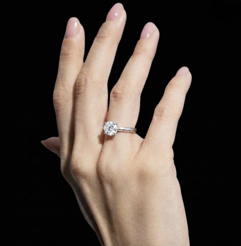 Solitaire ring worn on a hand